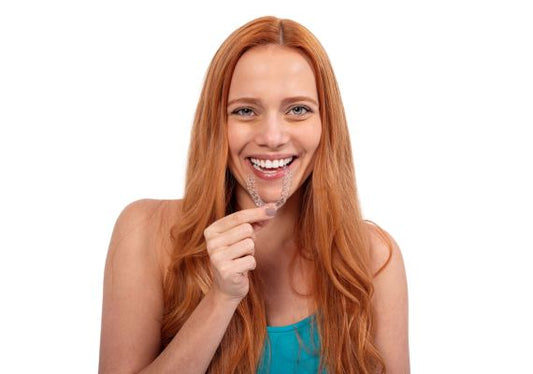 A girl is holding Caspersmile Clear Aligners