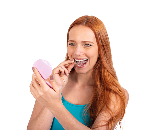 A girl holding a clear aligner
