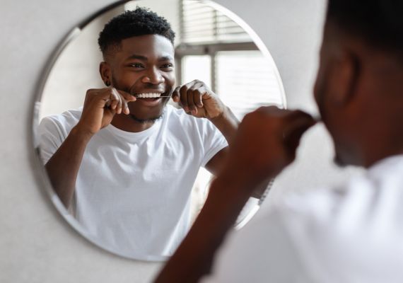 A person flossing teeth