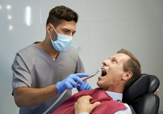 Dentist treating patient.