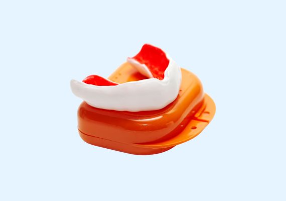 Image of an orange and white mouth guard with its case.
